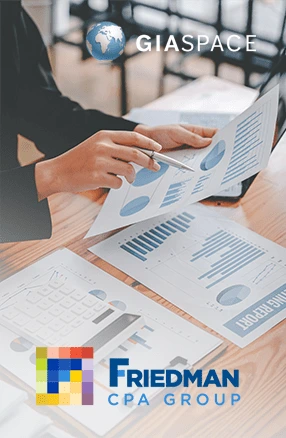 Person reviewing financial charts on a desk, with the GIASPACE globe logo above and the Friedman CPA Group logo below.
