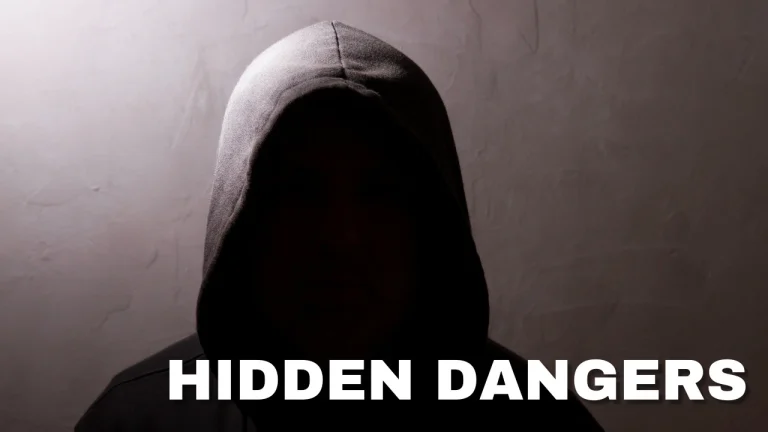 Hooded silhouette in dim light with bold 'HIDDEN DANGERS' caption.