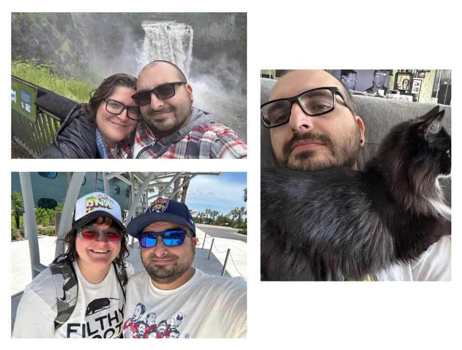 Couple taking a selfie in front of a waterfall outdoors, smiling at the camera in a scenic overlook.