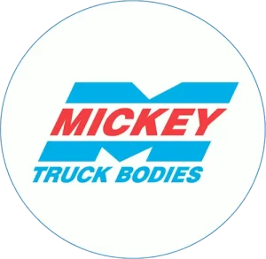 Mickey Truck Bodies logo in a white circular badge with blue and red lettering.